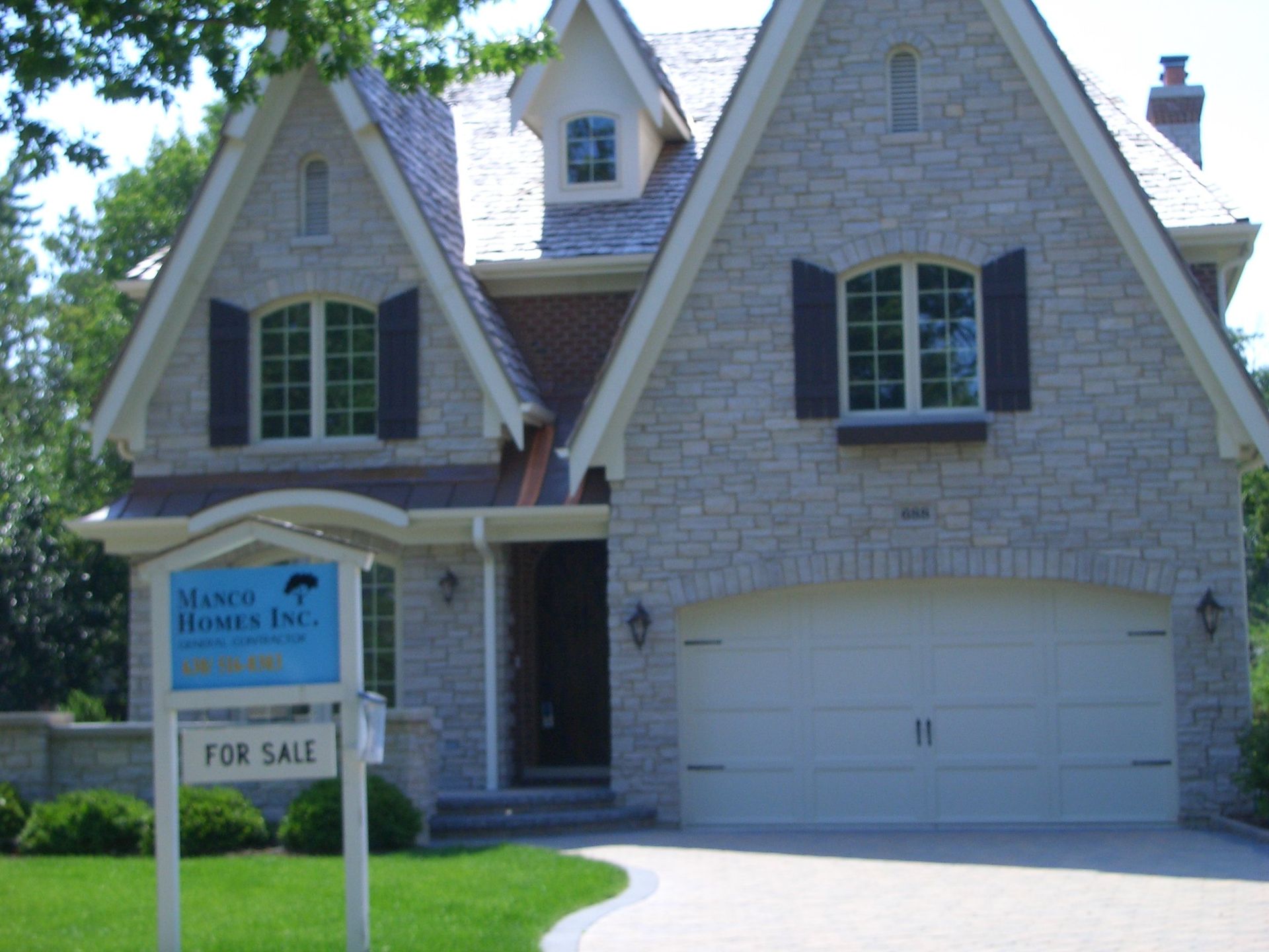 A house with a for sale sign in front of it