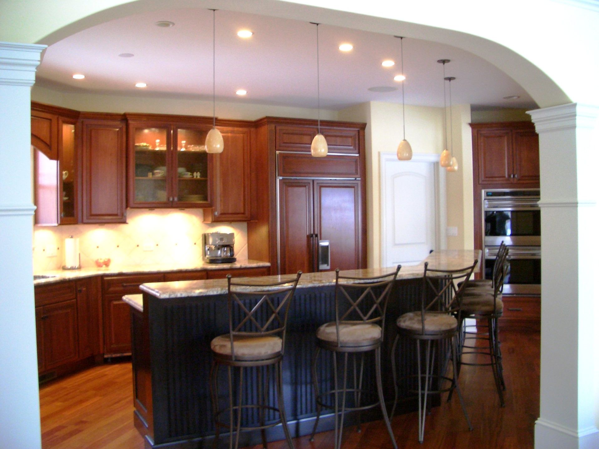 A kitchen with a large island and stools