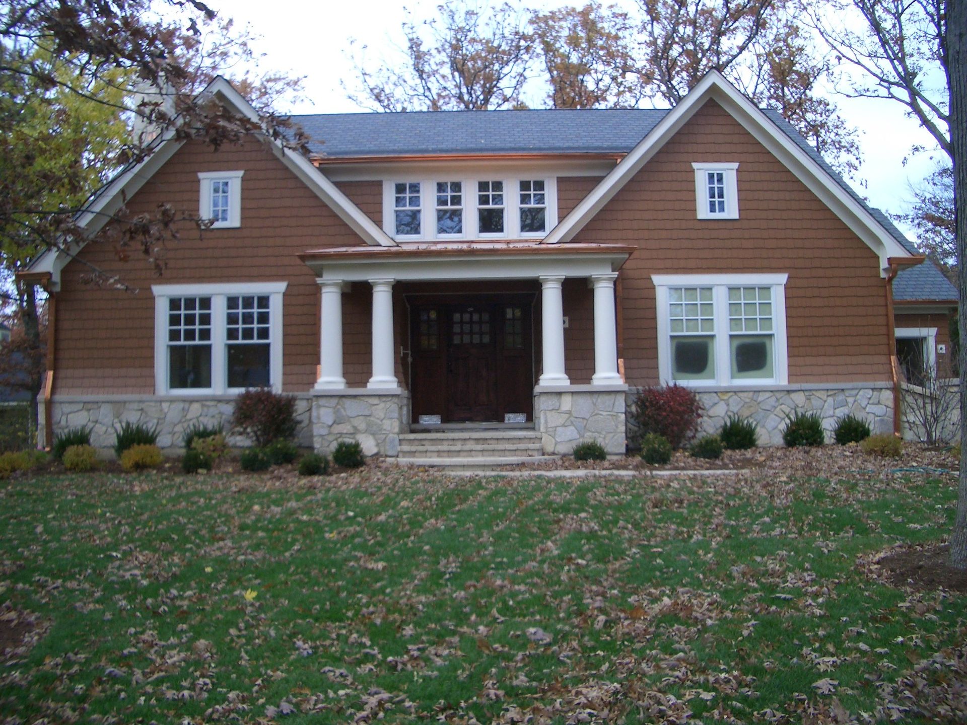 A house with a lot of windows and a porch