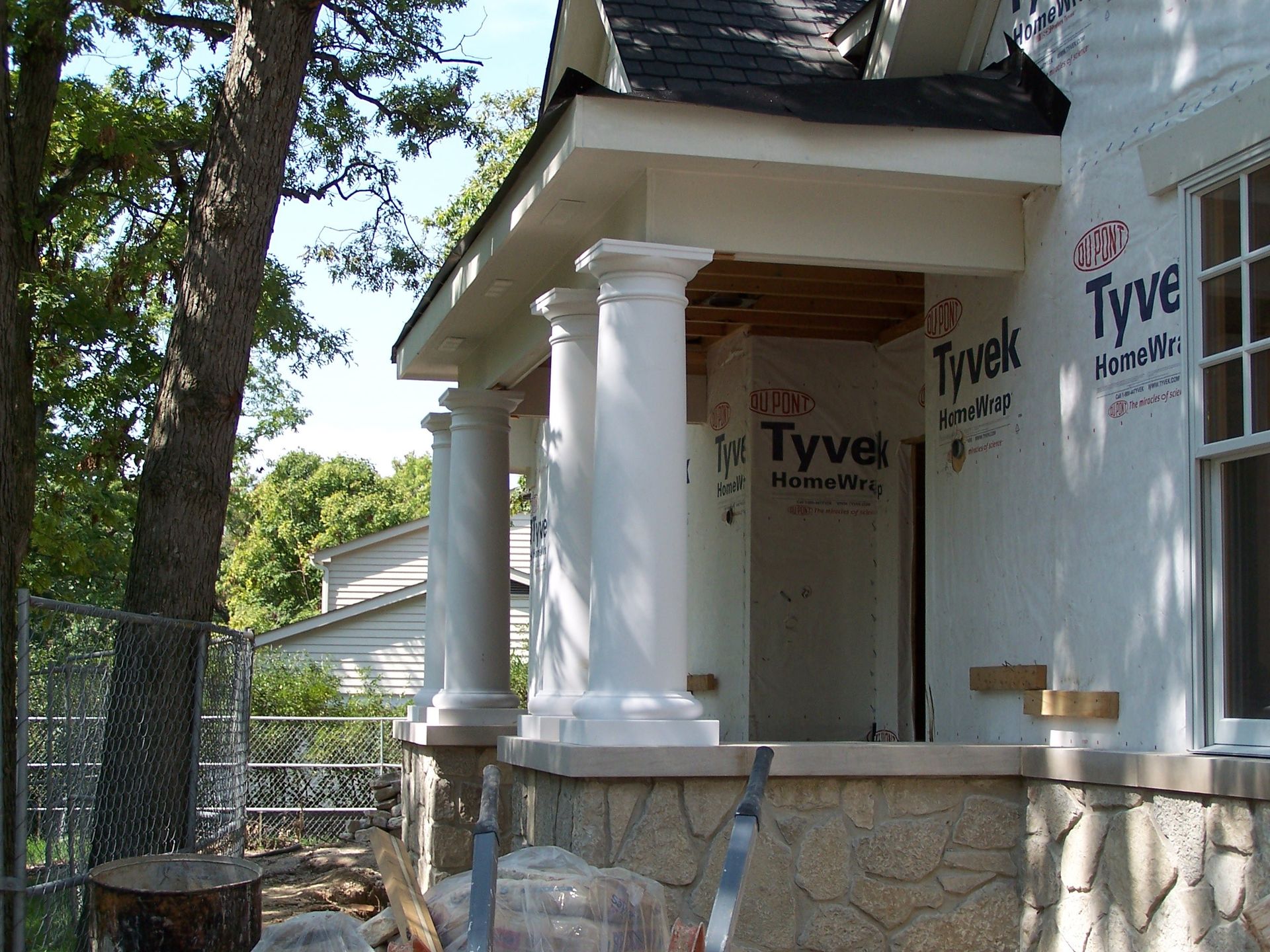 A house under construction with styrofoam covering the porch