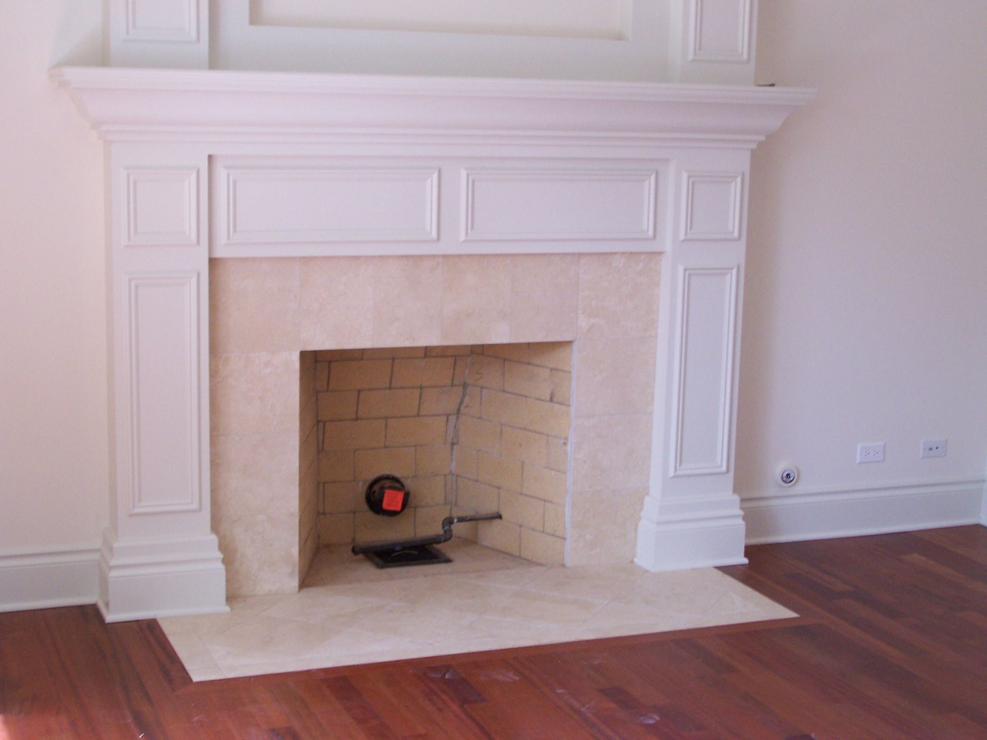 A fireplace with a white mantle in a living room