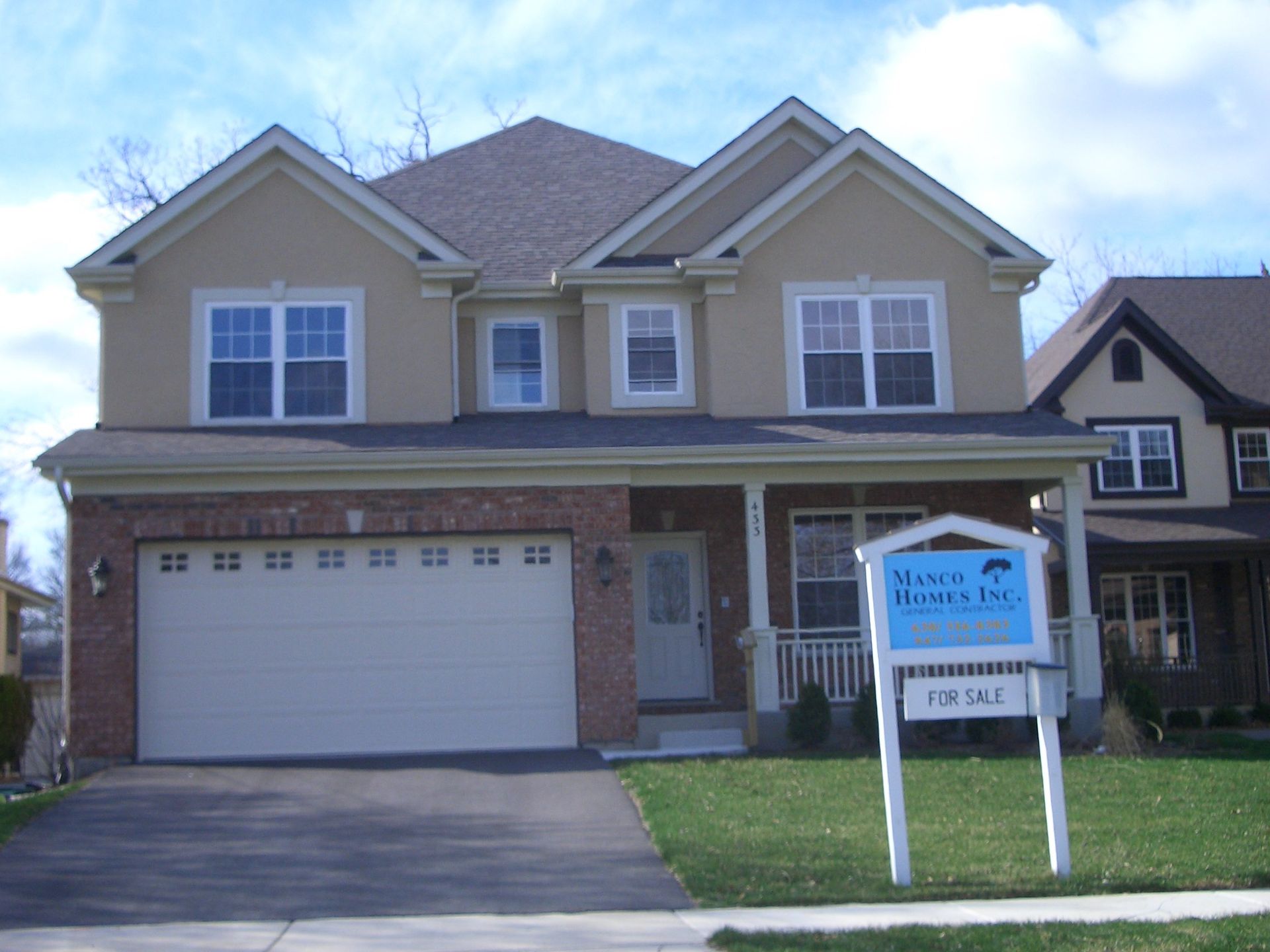 A house with a for sale sign in front of it
