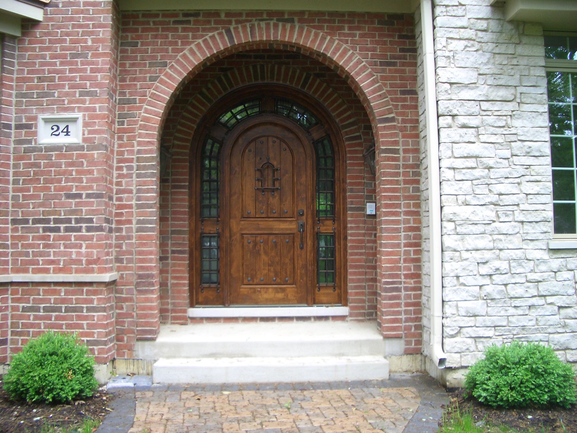 The front door of a brick house with the number 31 on it