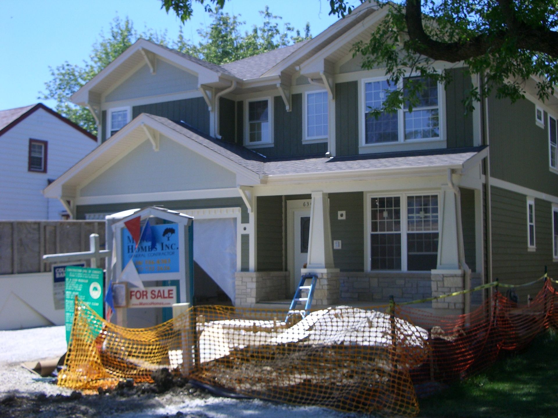A house with a for sale sign in front of it