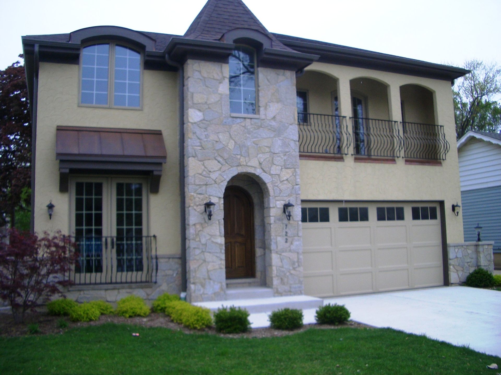 A large house with a garage and a balcony