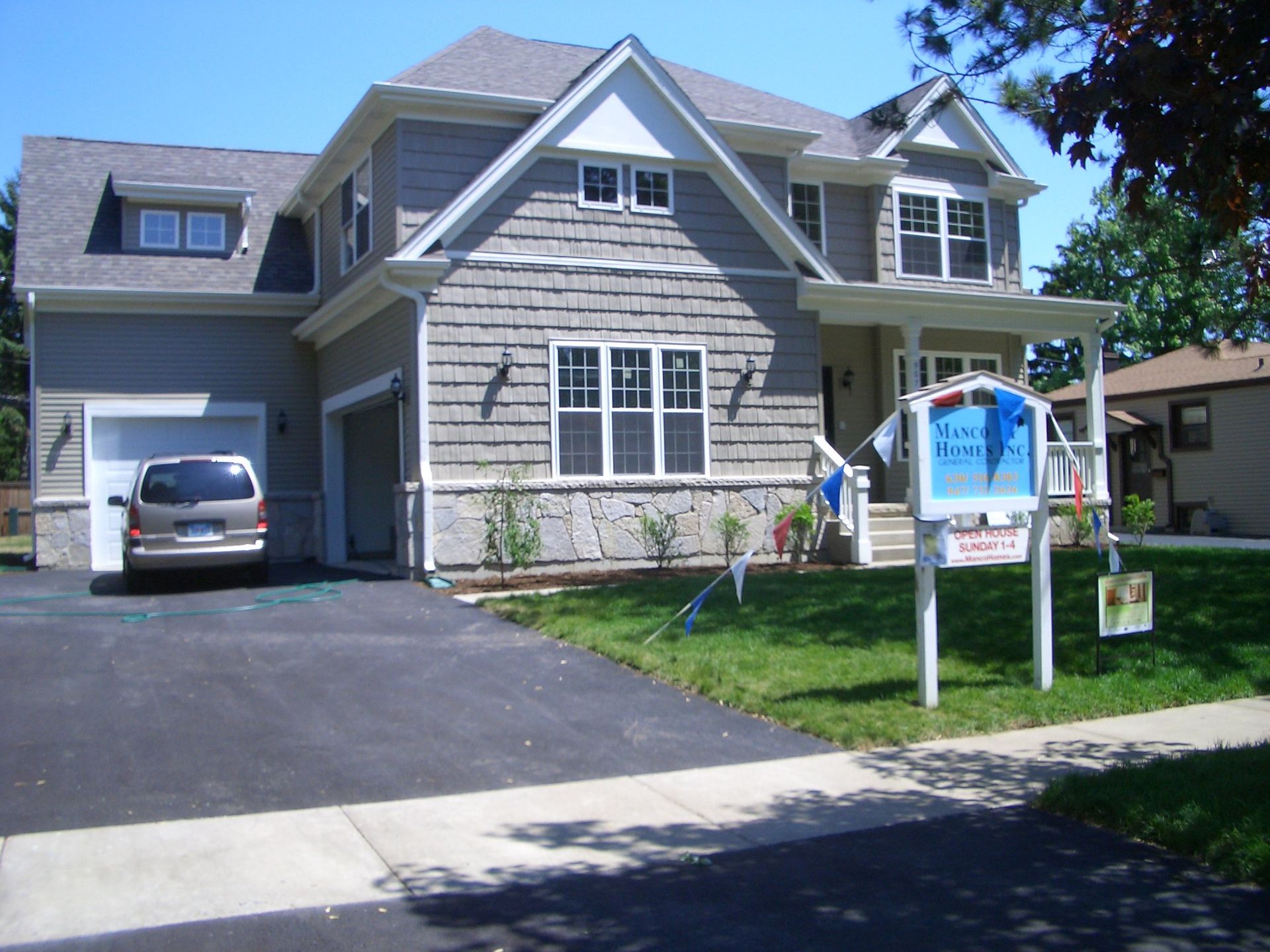 A house with a for sale sign in front of it