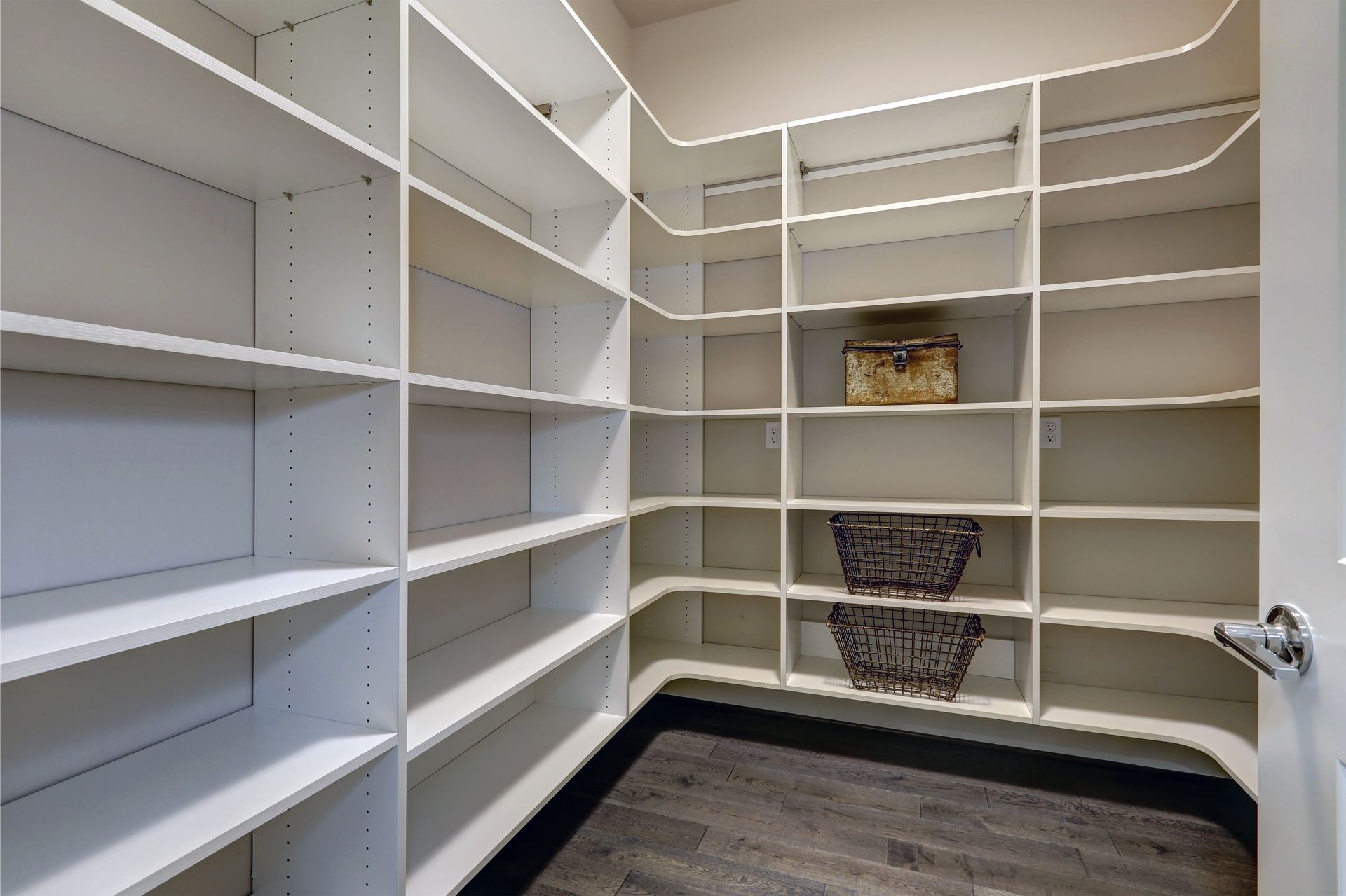 An empty walk in closet with lots of shelves