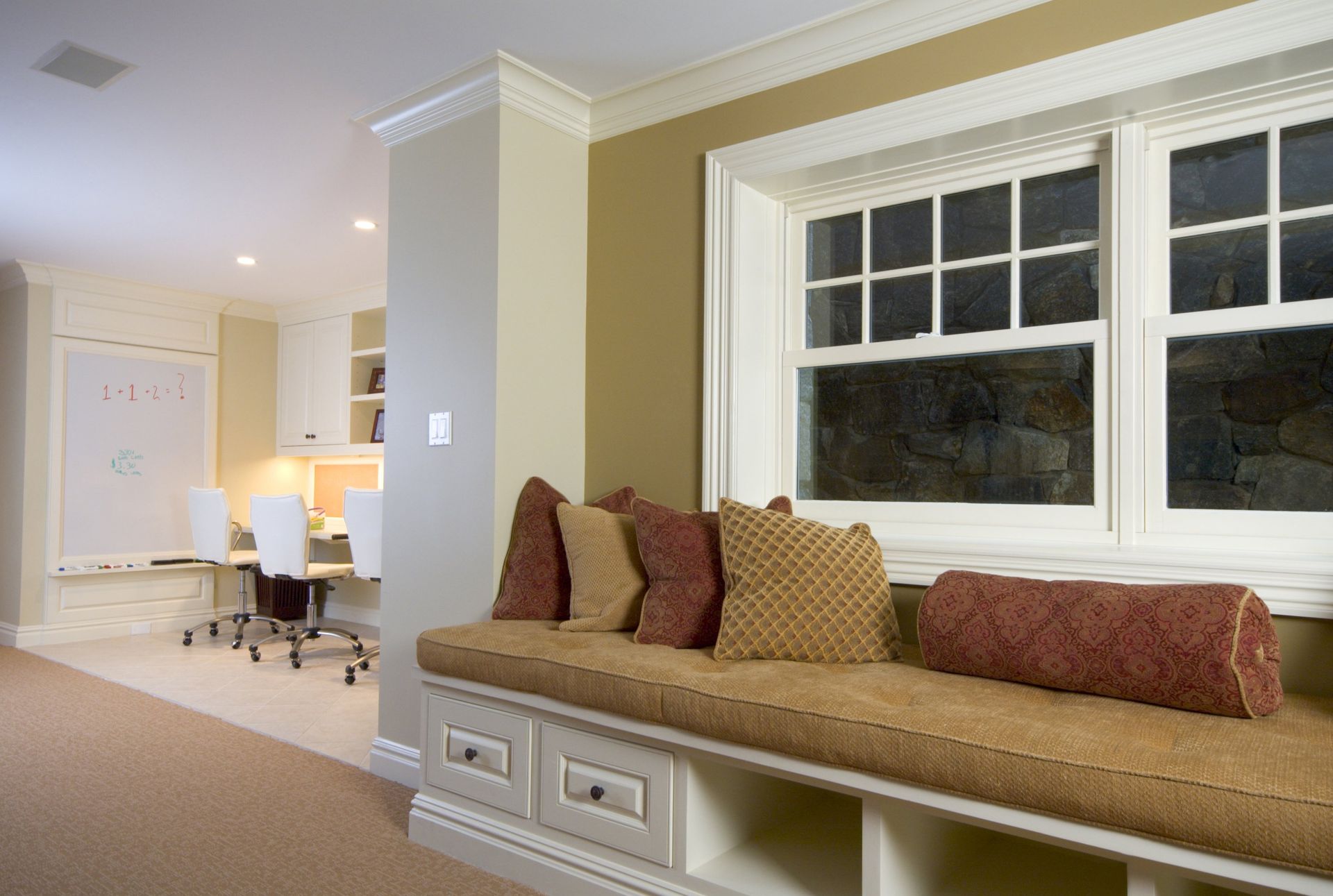 There is a window seat in the corner of the room.