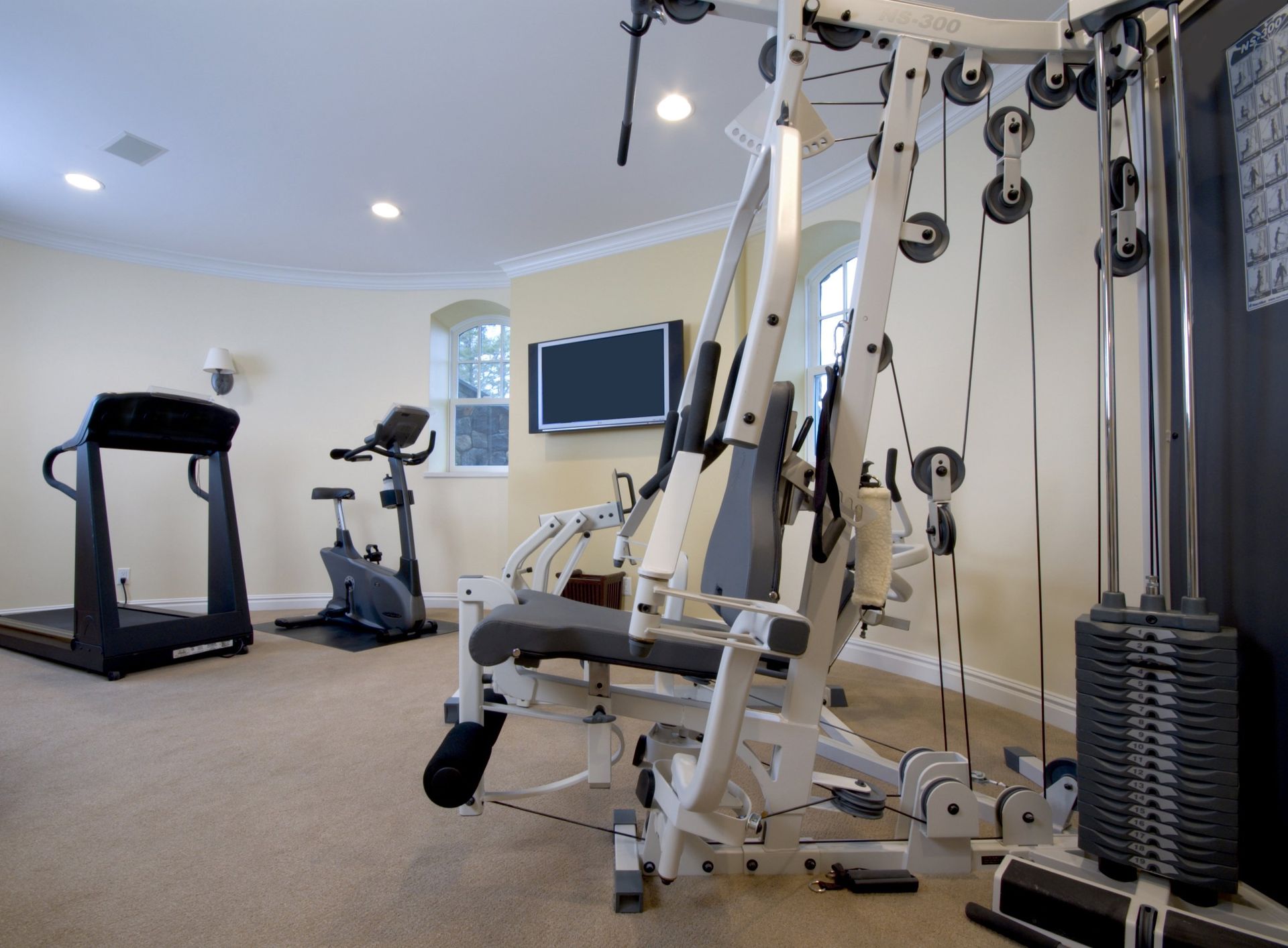 A home gym with a treadmill and a bicycle