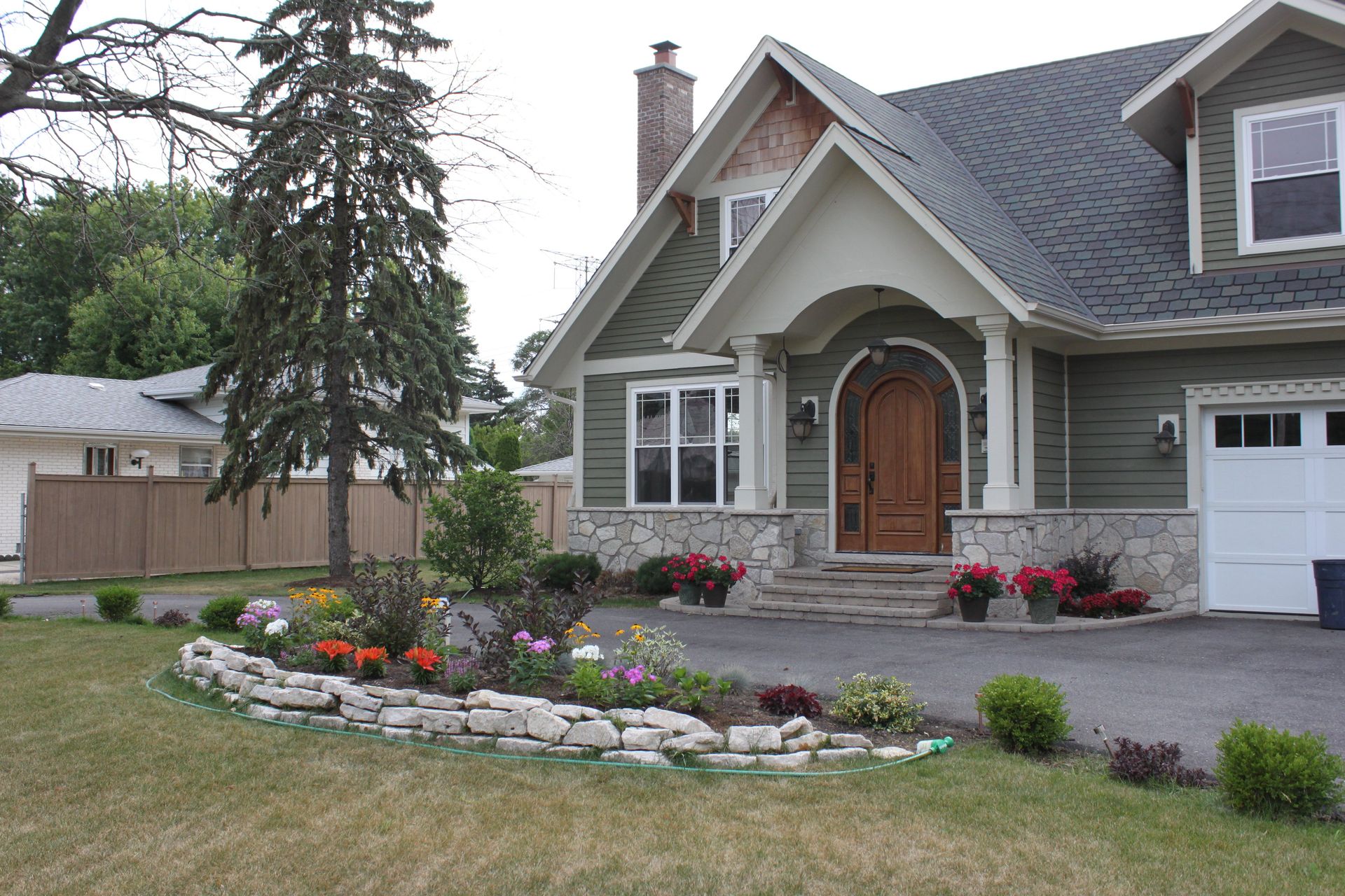 The front of a house with flowers in front of it