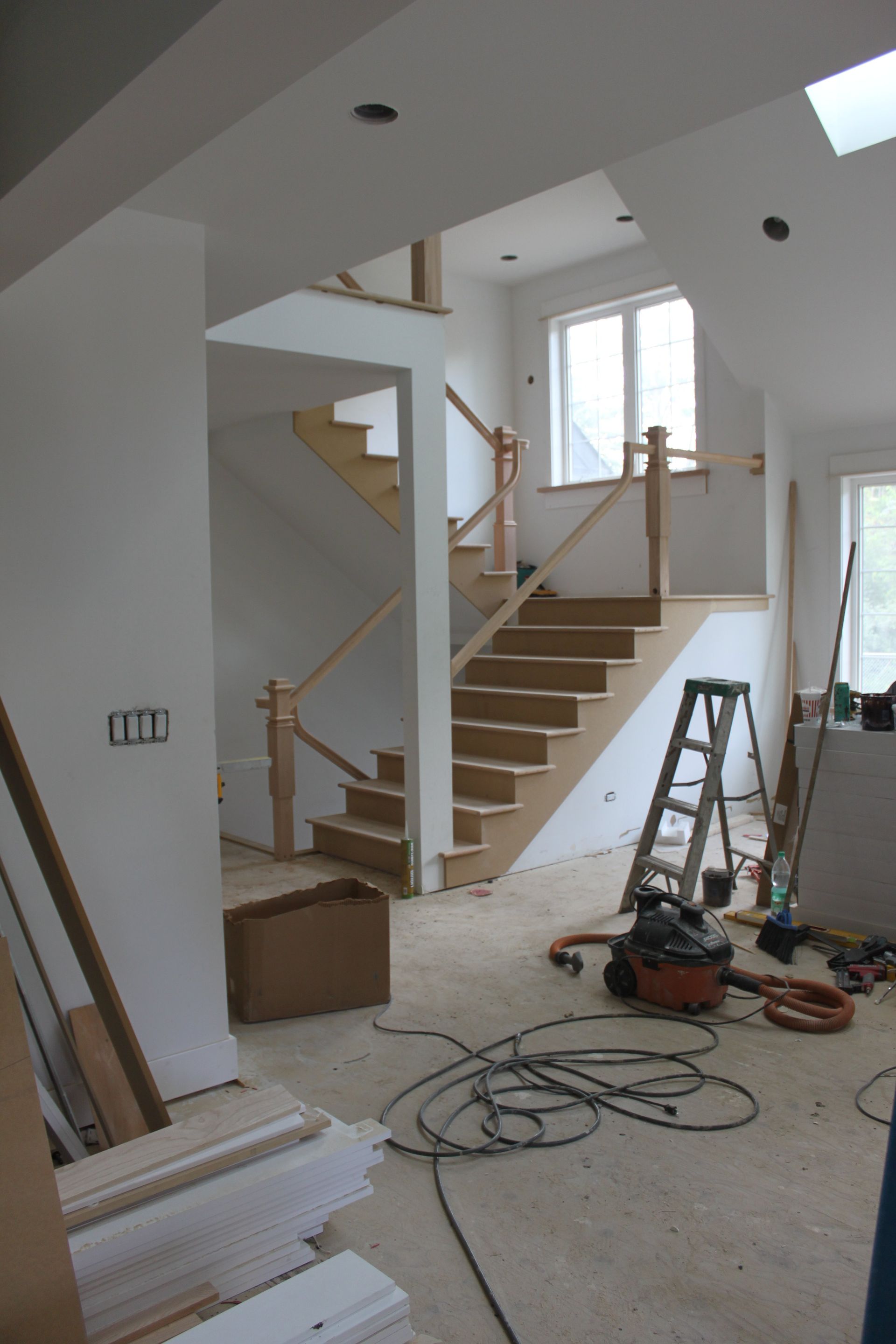A room with stairs and a ladder in it