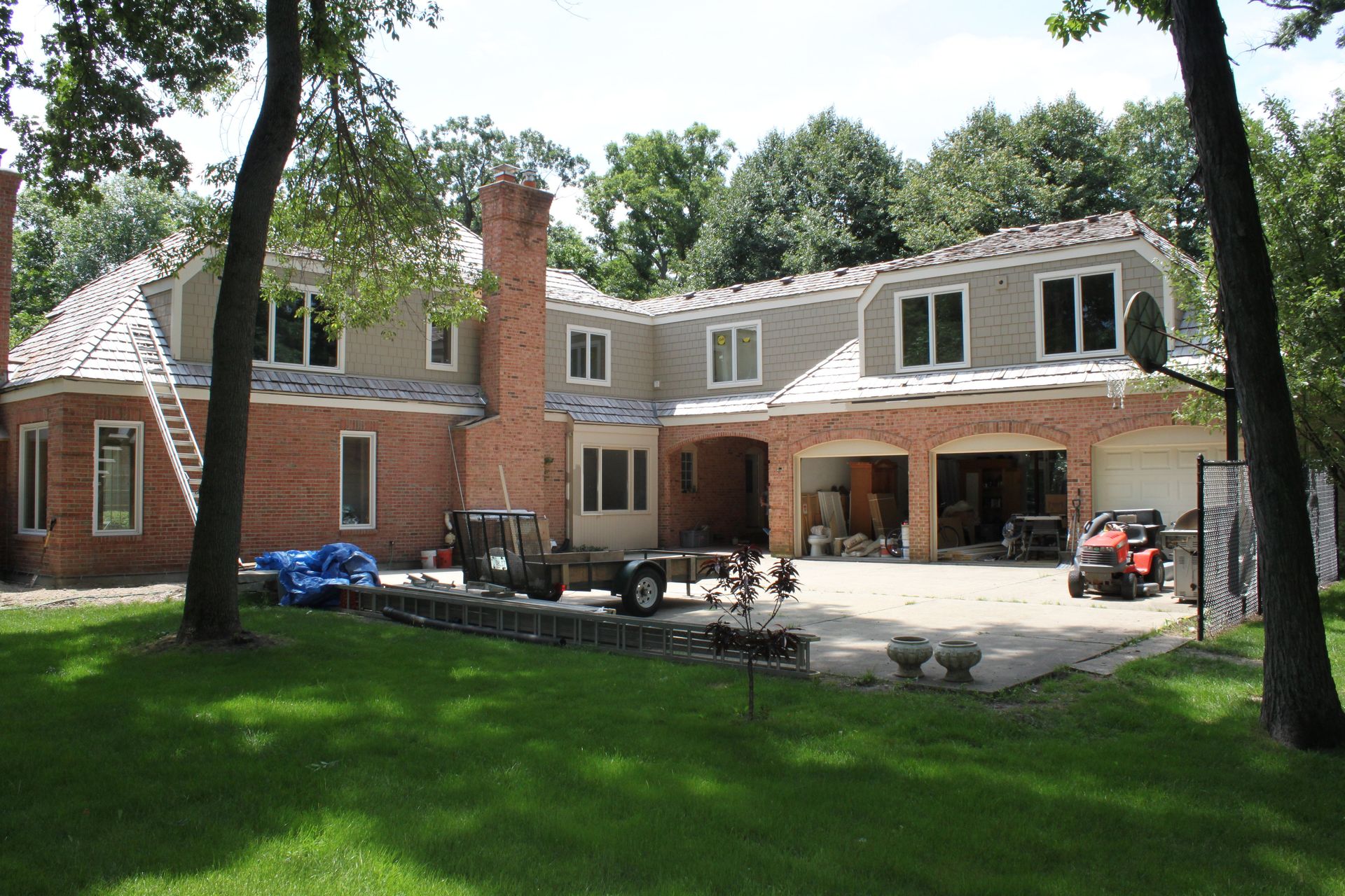 A large brick house with a jeep parked in front of it