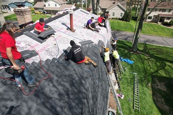 A group of people are working on a roof