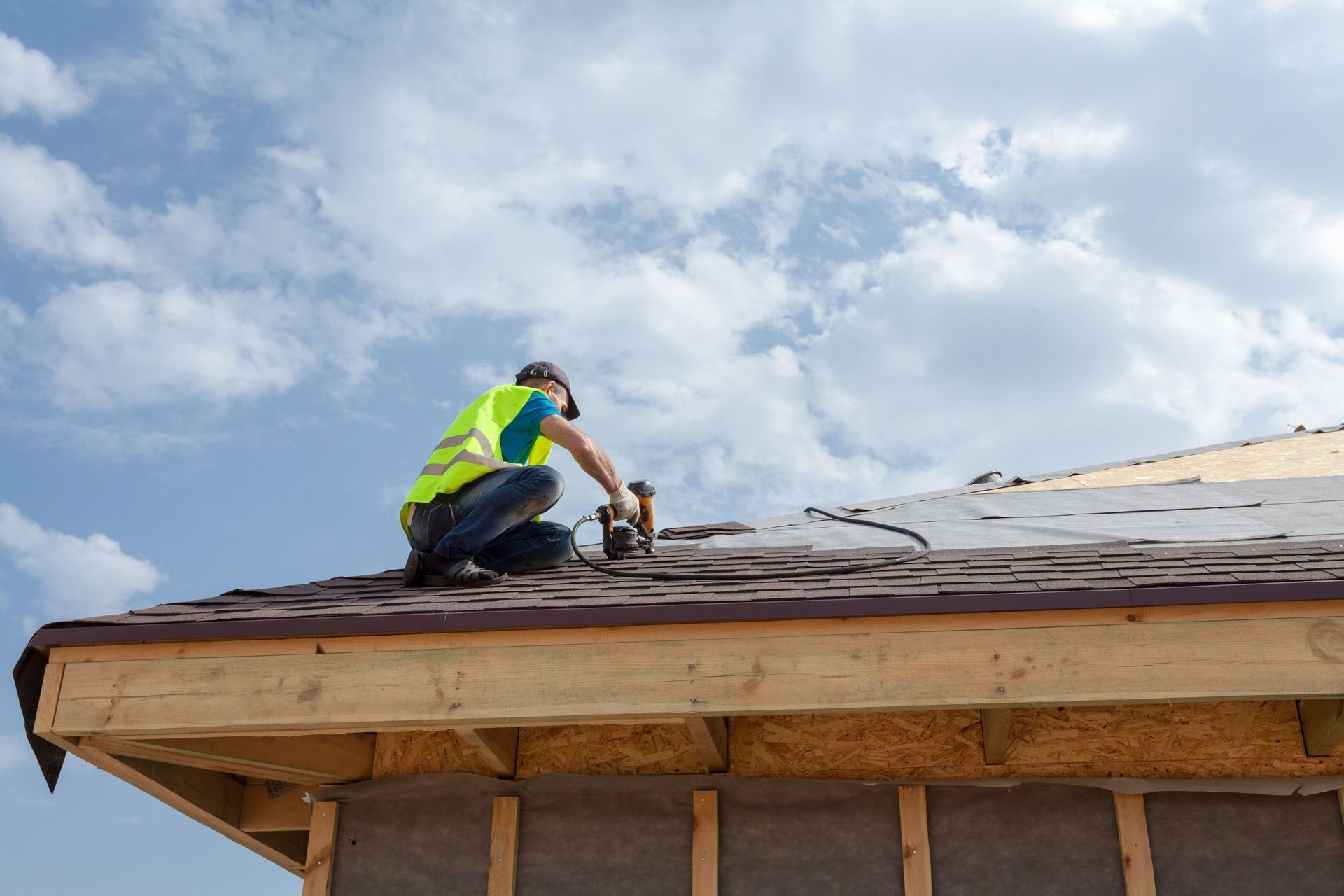 A man is working on the roof of a building.