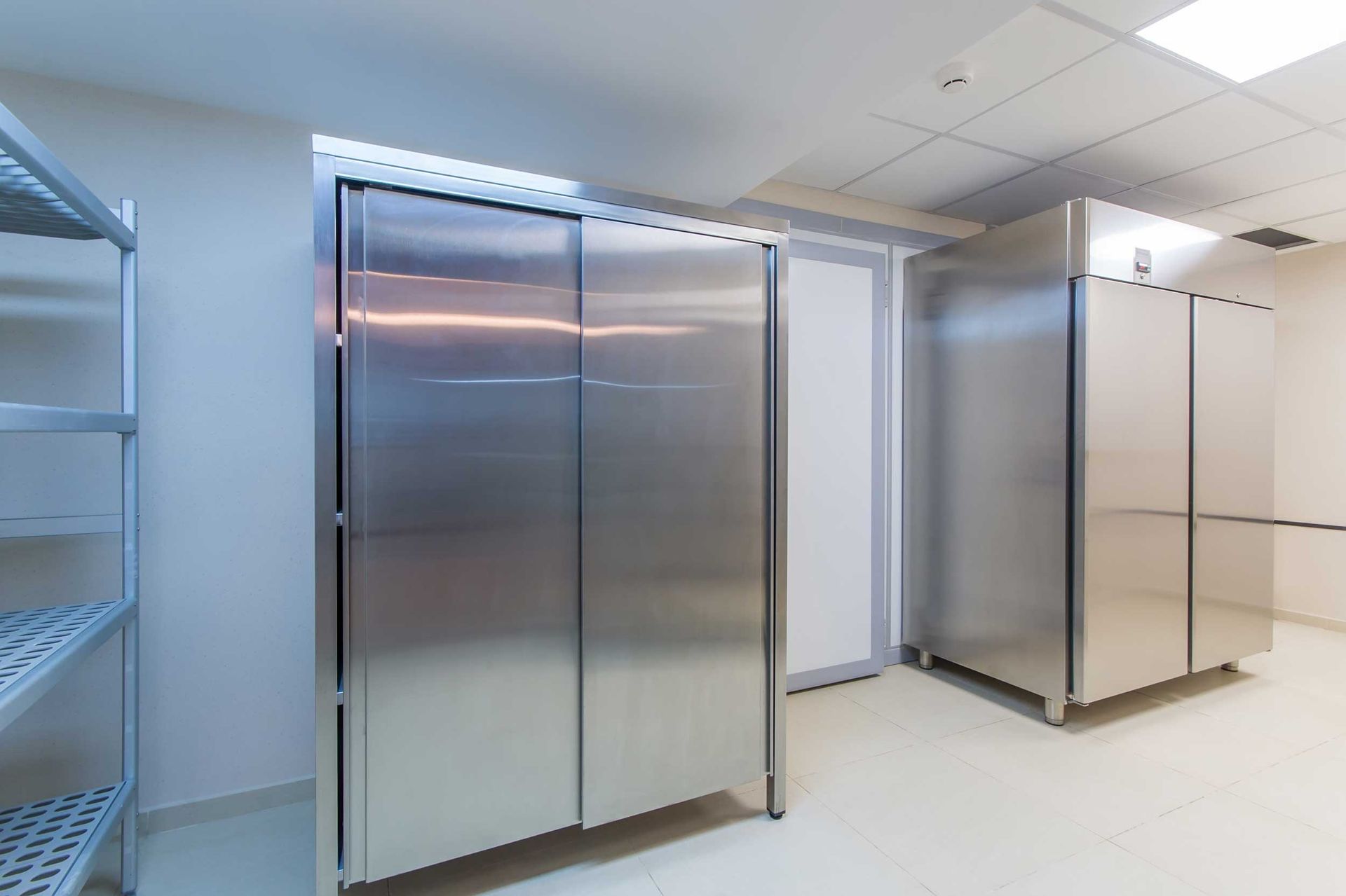 Fridge and shelves in a professional kitchen, after commercial refrigeration maintenance.