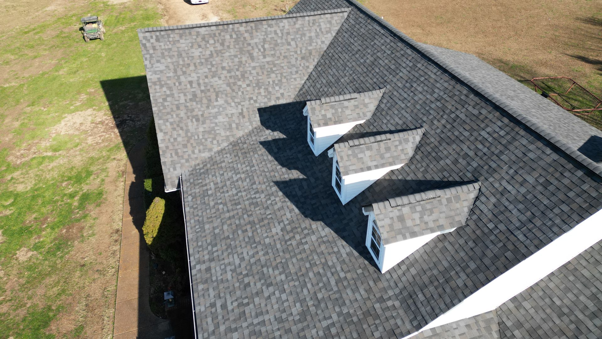New gray shingle roof on two-story home by Red Line Roofing in Dickson, TN