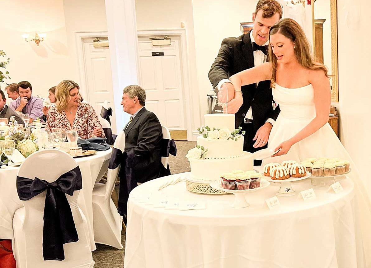 Bride and groom cutting wedding cake