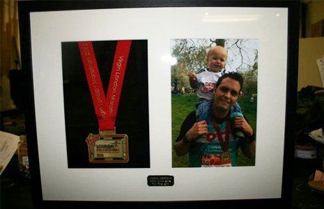 London marathon medal framed with photo of father and son