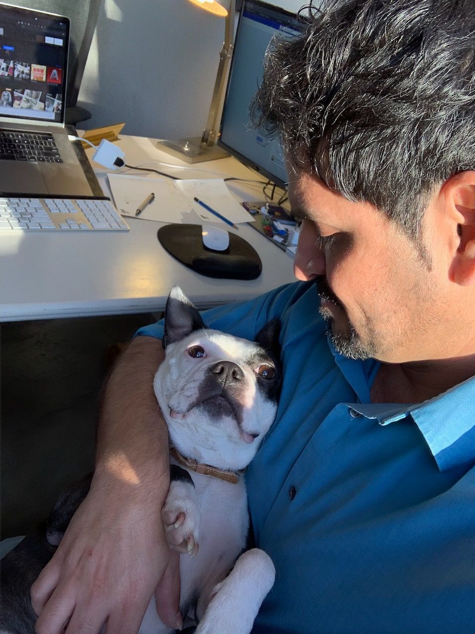 Cesar Torres holding Jesse at Desk