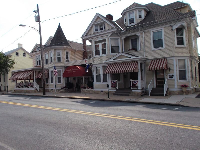 A row of houses with striped awnings on the side of the road