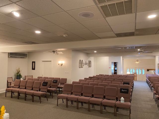 A large room with rows of chairs in a church.