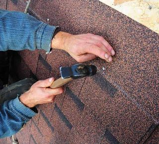 Roofer reinstalls roof shingles — Roofing Repairs in College Place, WA