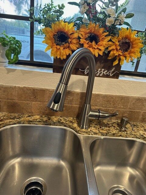A kitchen sink with a sign that says blessed on it