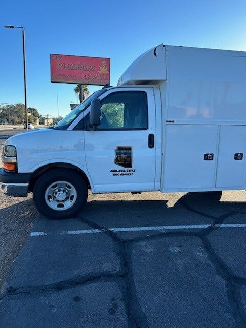 A bunch of pipes are sitting on top of a wooden floor.
