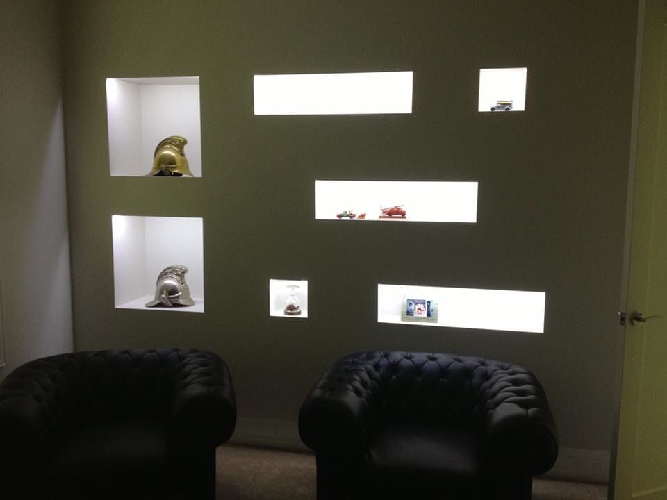 A Room With Two Chairs And A Wall With Shelves — GJT Electrical In Warners Bay, NSW