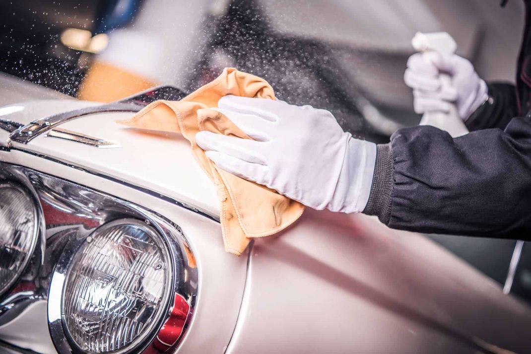 polishing the hood of classic car
