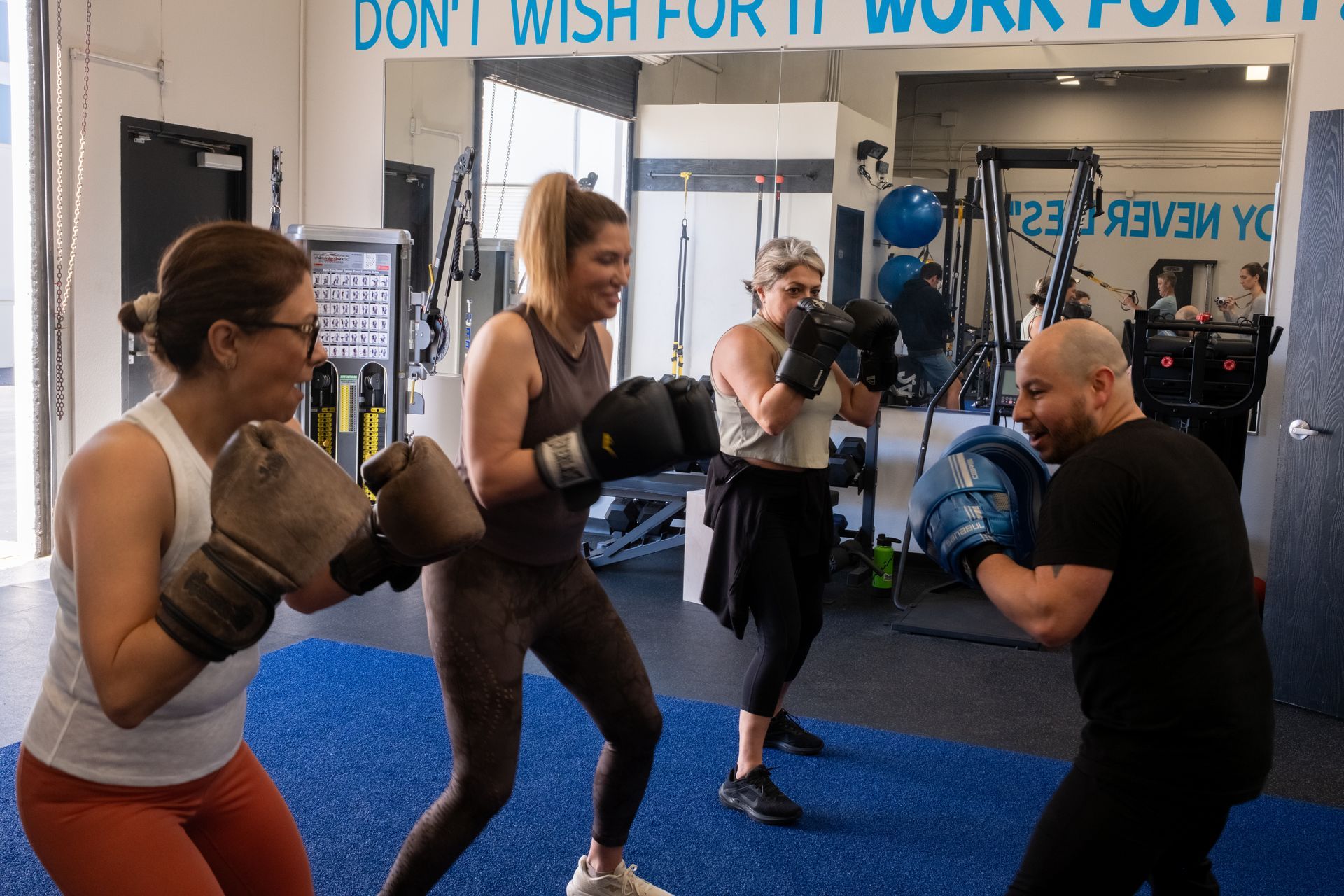 A group of people are boxing in a gym.