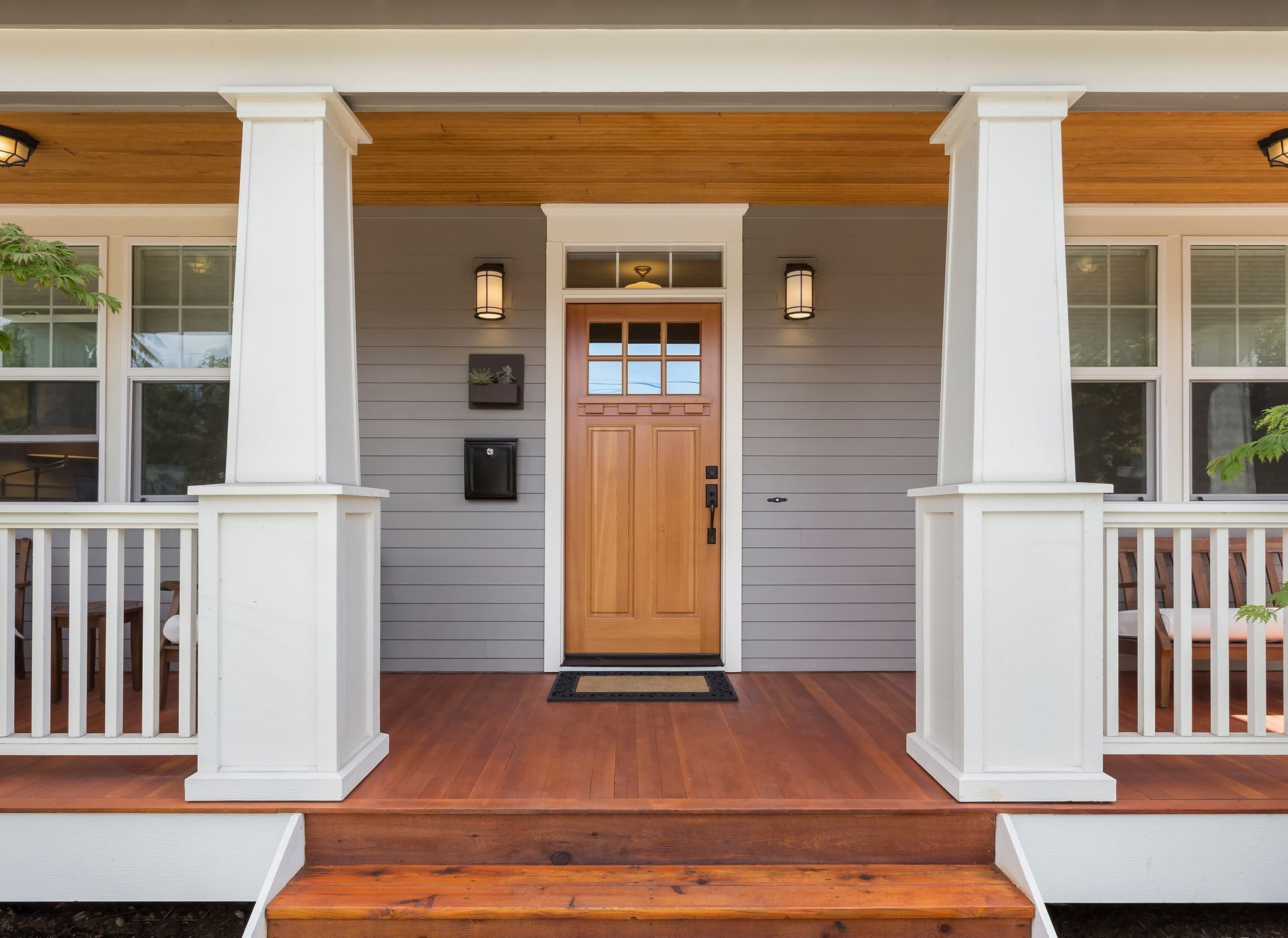 The front porch of a house with a wooden door