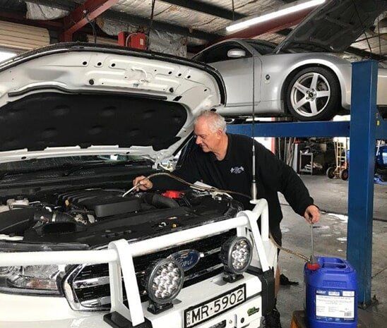 Mechanic Repairing Car Engine — Automotive in Edgeworth, NSW
