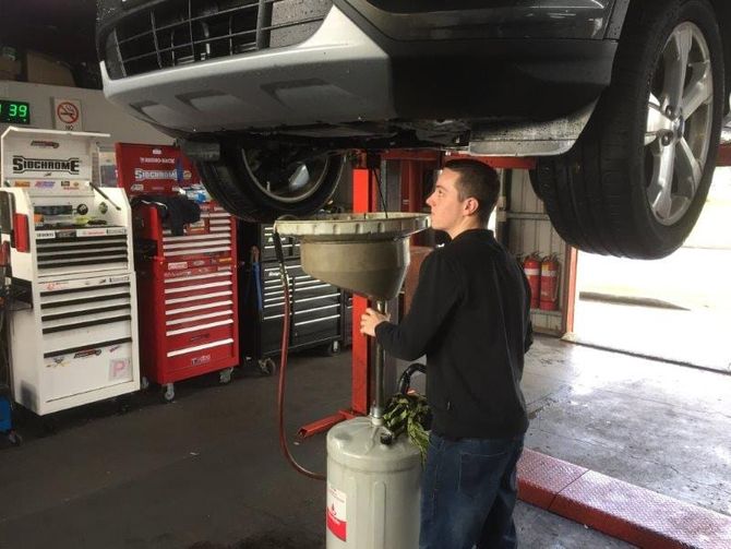 Mechanic Checking Under Car — Automotive in Edgeworth, NSW