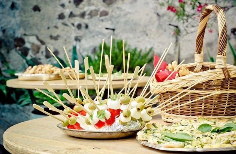 A table topped with plates of food and a basket of food.