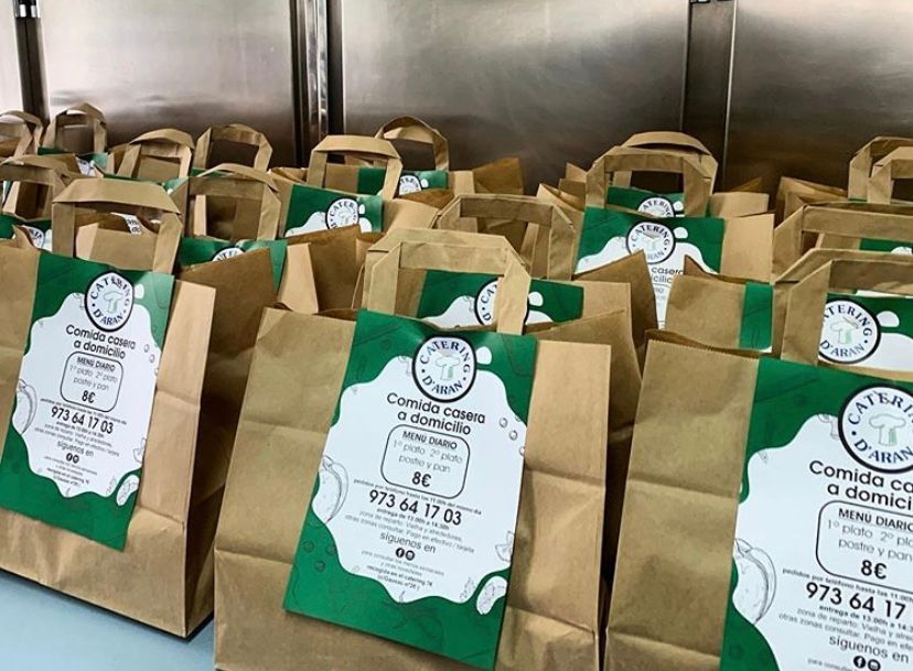 A bunch of brown paper bags with green labels on them