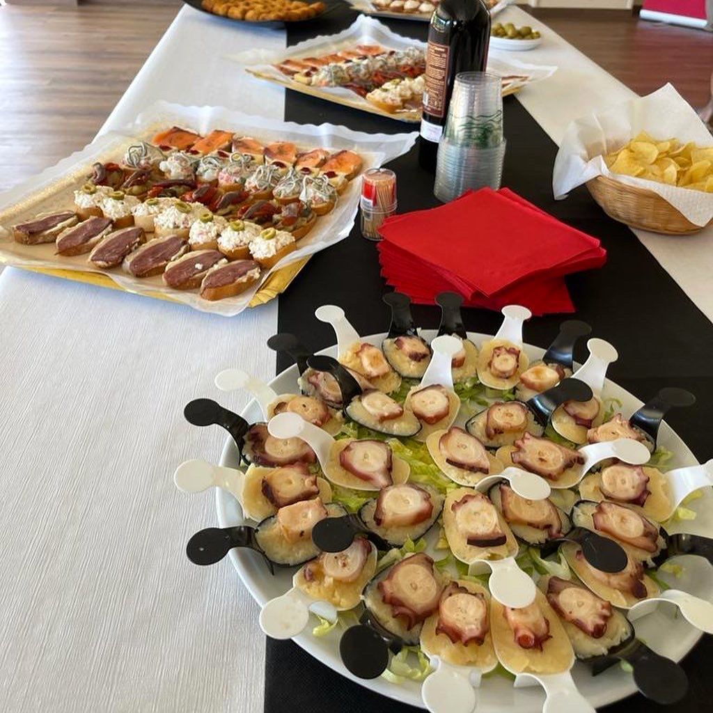 A table topped with plates of food and a basket of chips.