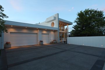 A large white house with a lot of garage doors