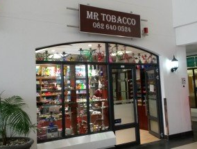 A store front with a sign that says mr tobacco