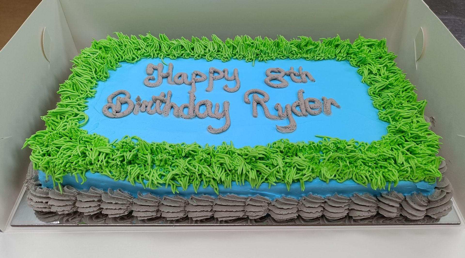 Birthday cake with blue frosting that says 