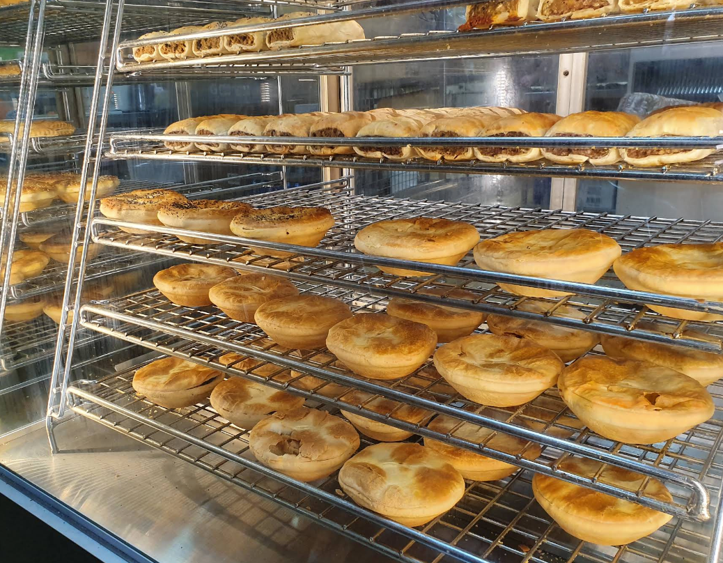 Display case filled with baked savory pies.— Atherton Bakehouse in Atherton, QLD