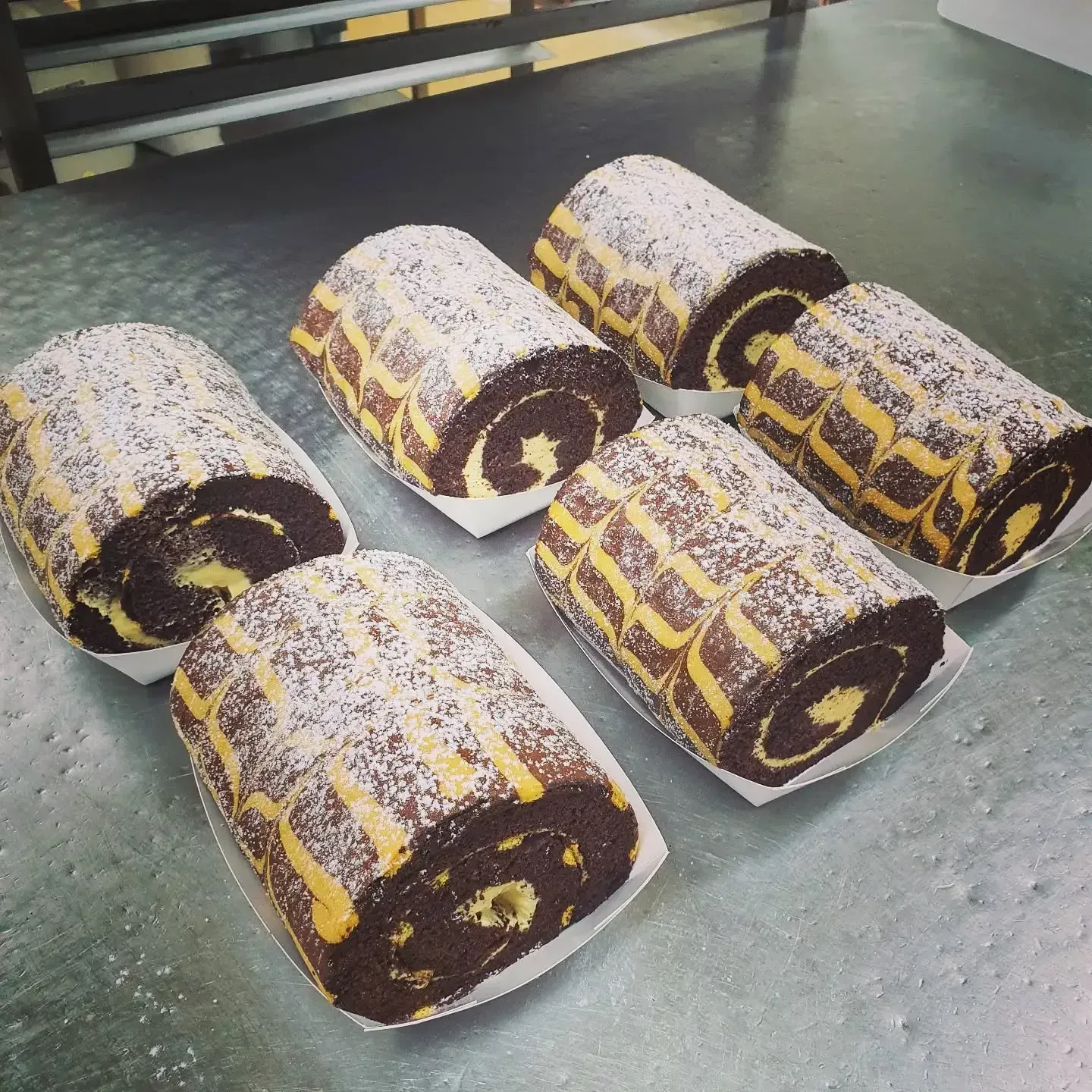 Six Chocolate Swiss Rolls Dusted With Powdered Sugar — Atherton Bakehouse in Atherton, QLD