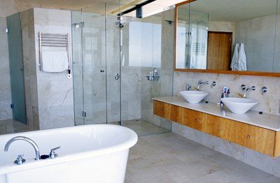 bathroom white tub gray tile glass shower