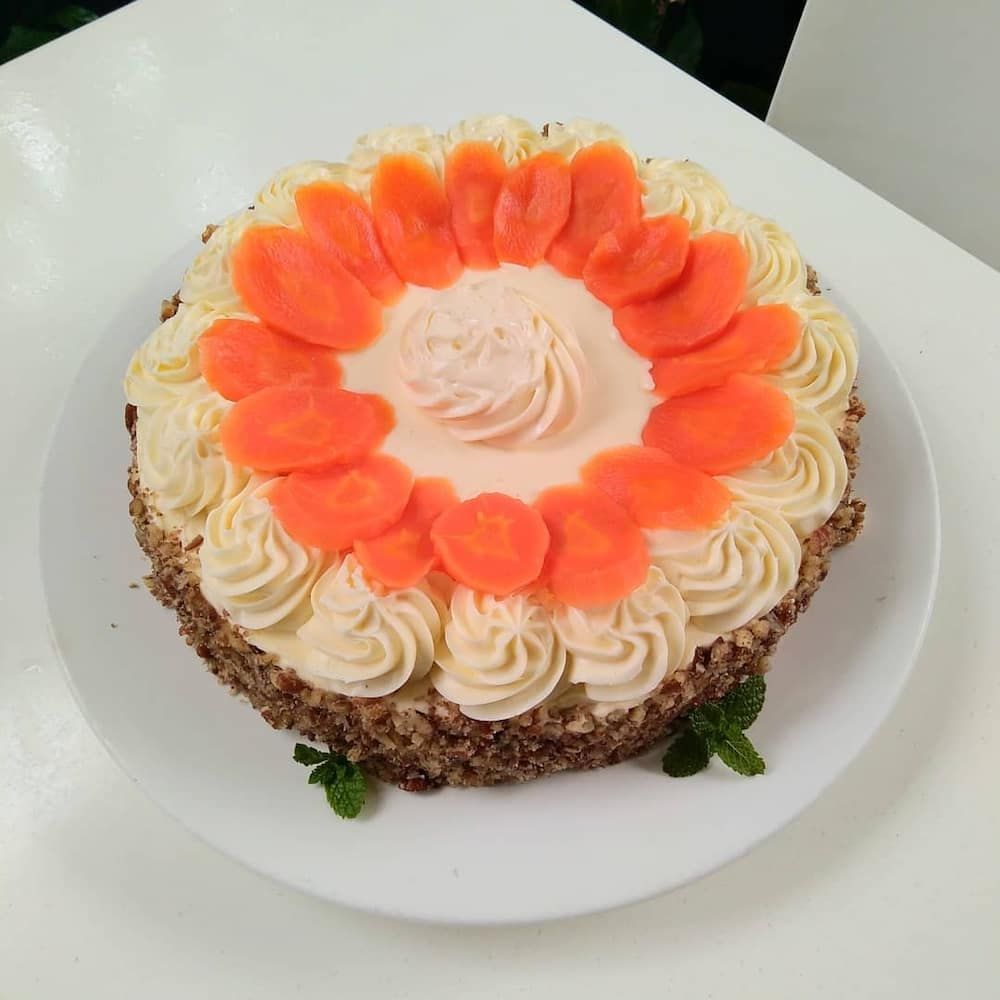 A Carrot Cake With Whipped Cream And Carrots On Top — Vines at 139 in Grafton, NSW