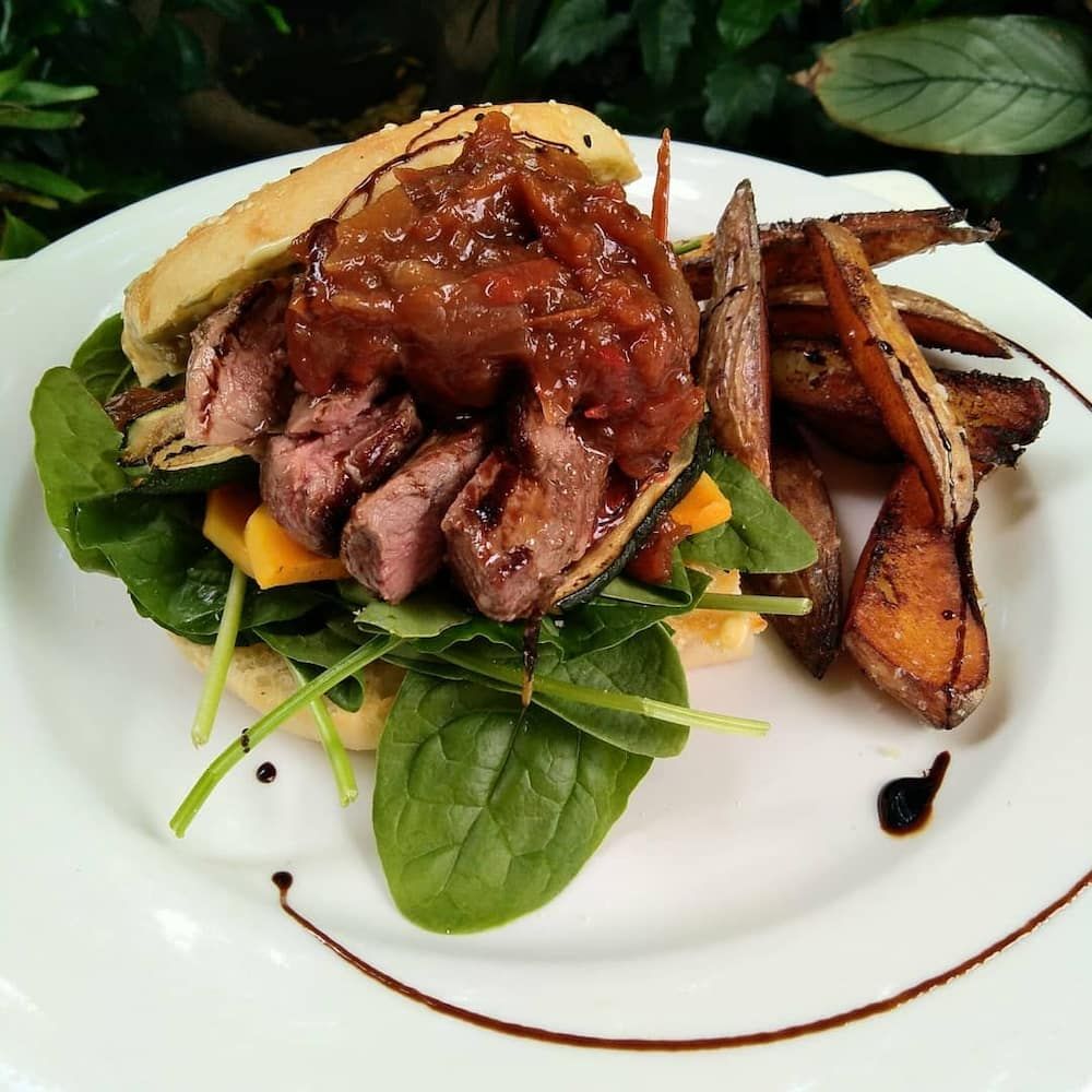 A White Plate Topped With A Sandwich And French Fries — Vines at 139 in Grafton, NSW