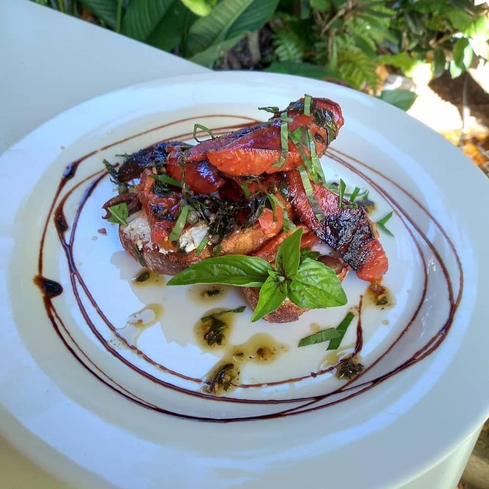A White Plate Topped With A Salad Of Tomatoes And Basil — Vines at 139 in Grafton, NSW