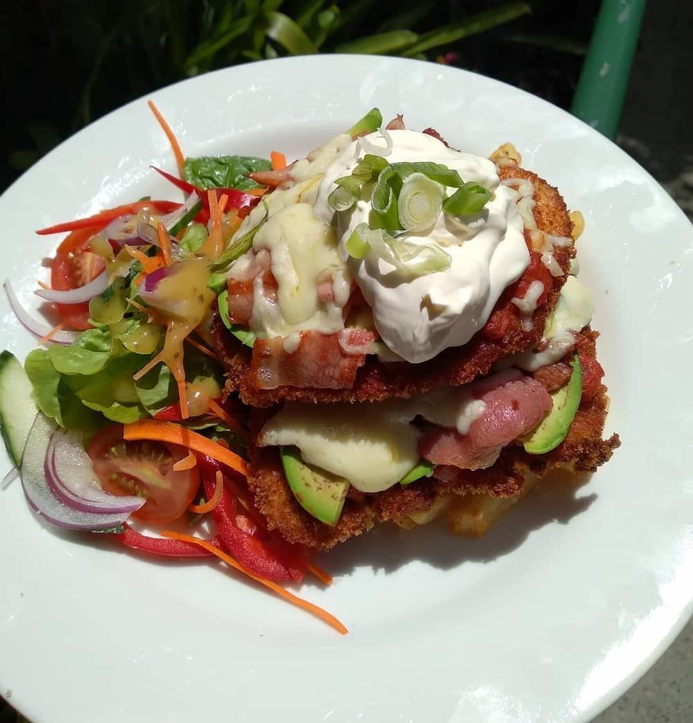 A White Plate Topped With A Sandwich And Vegetables — Vines at 139 in Grafton, NSW