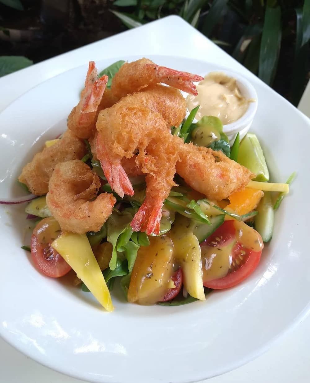 A Plate Of Food With Shrimp And Vegetables On A Table — Vines at 139 in Grafton, NSW