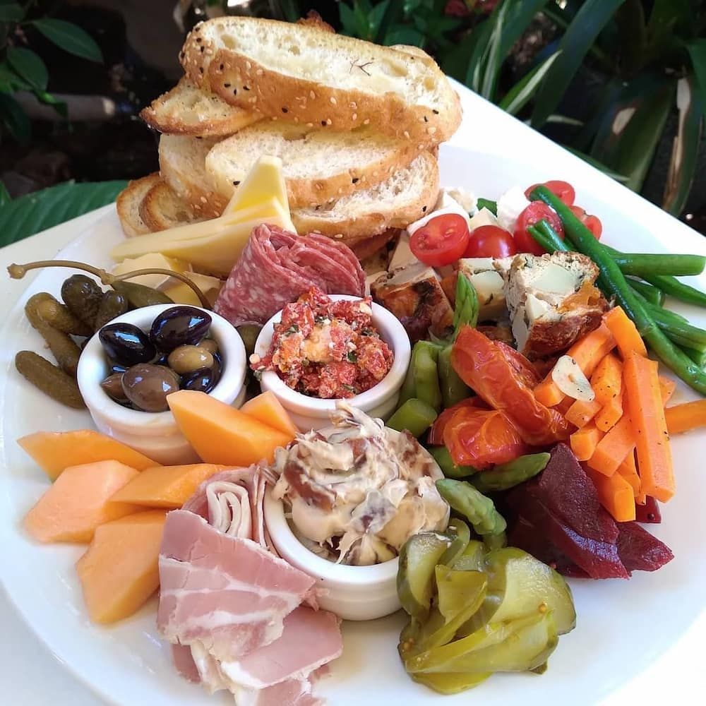 A White Plate Topped With Meats And Vegetables — Vines at 139 in Grafton, NSW