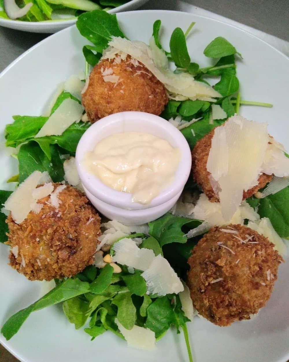 A White Plate Topped With Fried Food And A Small Bowl Of Sauce — Vines at 139 in Grafton, NSW